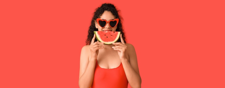 Eine Frau genießt ein erfrischendes Stück Wassermelone.